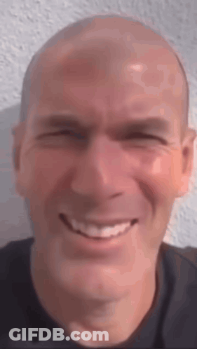 A Close Up Of A Man 'S Face With A Smile On His Face . GIF