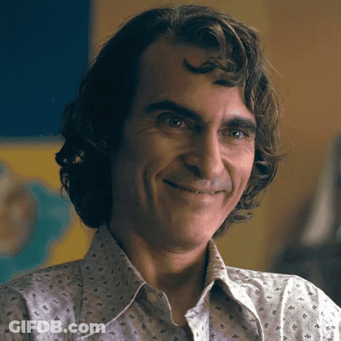 A Close Up Of A Man 'S Face With A Smile On His Face GIF