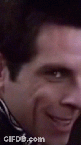 A Close Up Of A Man 'S Face With A Smile On His Face GIF