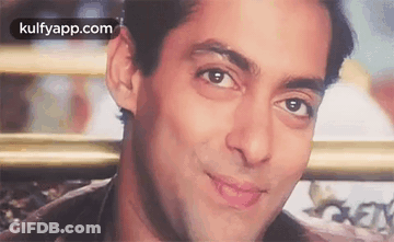 A Close Up Of A Man 'S Face With A Smile On His Face And A Blurred Background . GIF