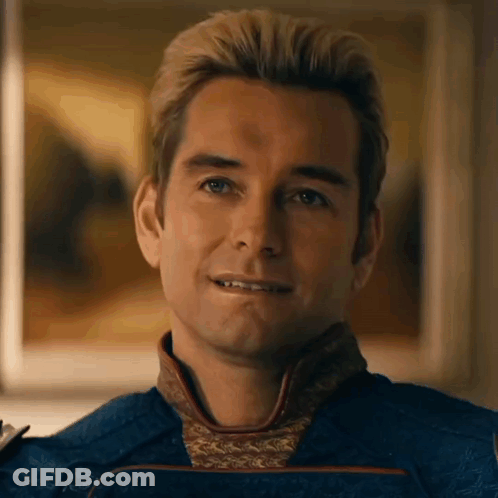 A Close Up Of A Man 'S Face With A Smile On His Face And A Painting In The Background . GIF
