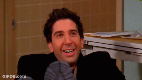 A Close Up Of A Man 'S Face With A Smile On His Face And His Feet Up GIF