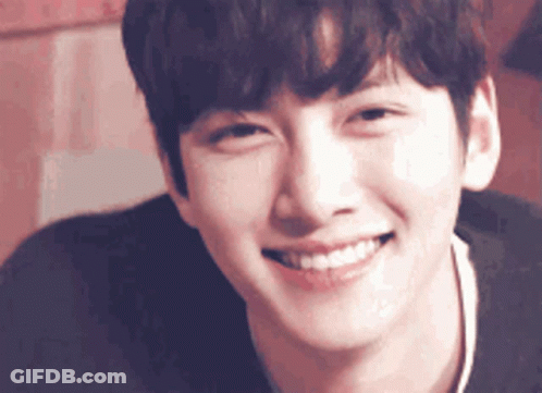 A Close Up Of A Man 'S Face With A Smile On His Face GIF