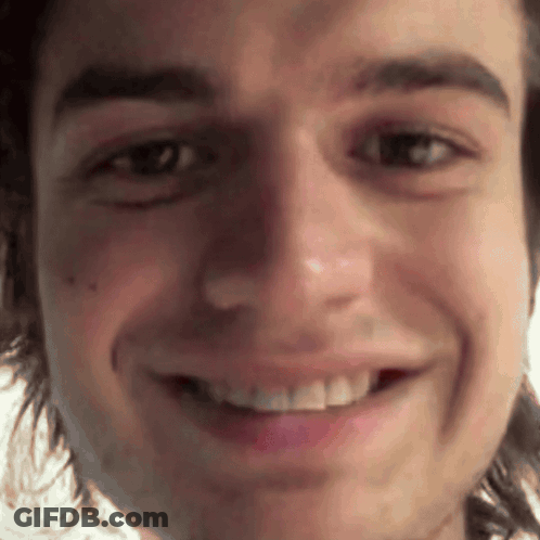 A Close Up Of A Man 'S Face With A Smile On It GIF