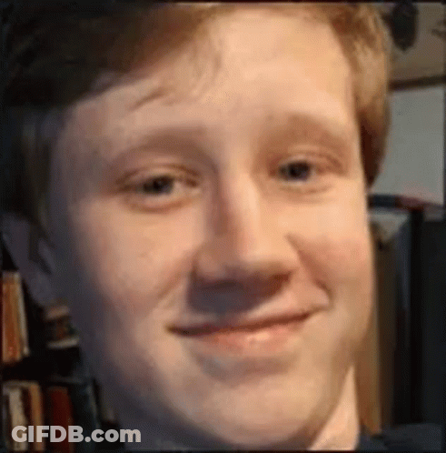 A Close Up Of A Man 'S Face With A Smile On It . GIF