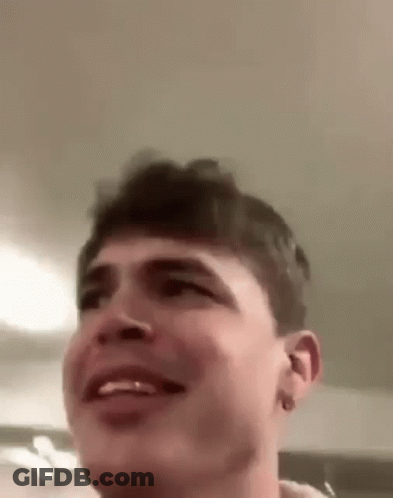 A Close Up Of A Man 'S Face With A Smile On It . GIF