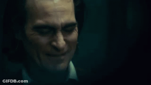 A Close Up Of A Man 'S Face With A Smile On It . GIF