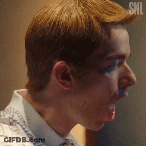A Close Up Of A Man 'S Face With A Snl Logo On His Head GIF