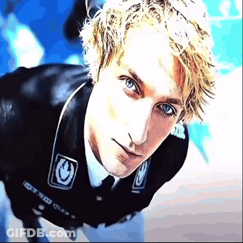 A Close Up Of A Man 'S Face With A Sticker On His Jacket That Says 100 GIF