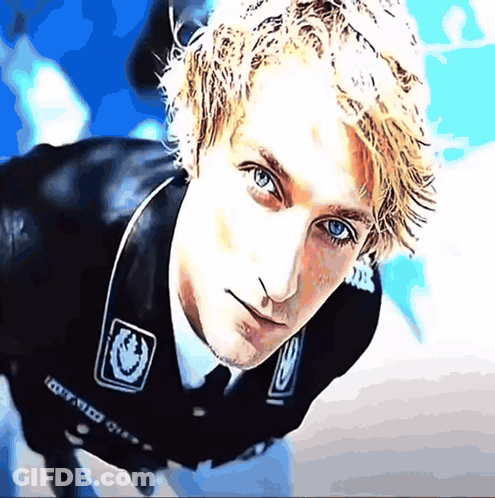 A Close Up Of A Man 'S Face With A Sticker On His Jacket That Says ' I Got Med ' On It GIF