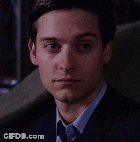 A Close Up Of A Man 'S Face With A Suit And Tie GIF