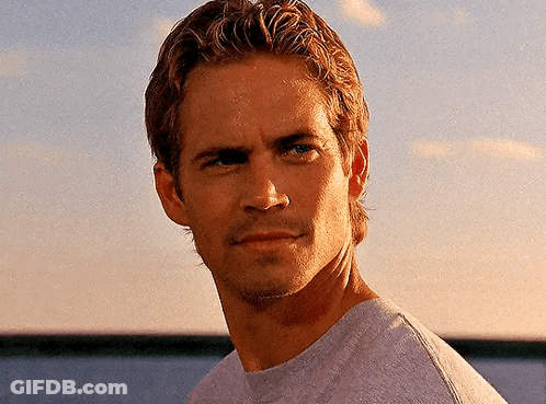 A Close Up Of A Man 'S Face With A Sunset In The Background GIF
