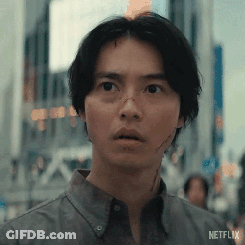 A Close Up Of A Man 'S Face With A Surprised Look On His Face In A City . GIF