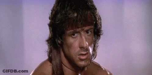 A Close Up Of A Man 'S Face With A Sword Around His Neck And A Choker . GIF