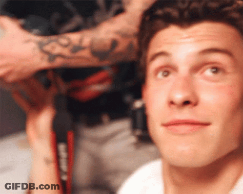 A Close Up Of A Man 'S Face With A Tattoo On His Arm That Says Casio GIF