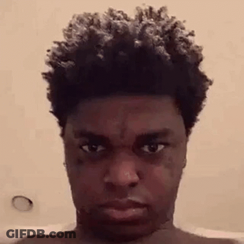 A Close Up Of A Man 'S Face With A Tattoo On His Forehead . GIF