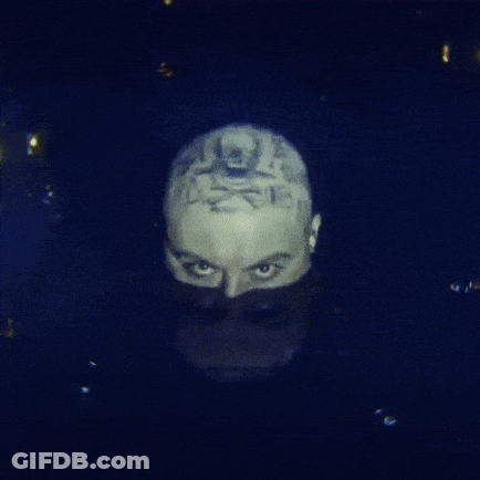 A Close Up Of A Man 'S Face With A Tattoo On It GIF