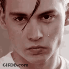 A Close Up Of A Man 'S Face With A Tear Coming Down His Cheek . GIF