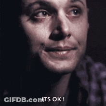 A Close Up Of A Man 'S Face With A Tear Coming Out Of His Eye And The Words Its Ok GIF
