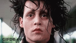 A Close Up Of A Man 'S Face With A Tear Coming Out Of His Nose . GIF