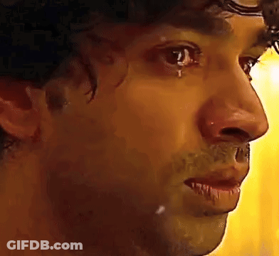 A Close Up Of A Man 'S Face With A Tear In His Eye . GIF