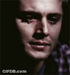 A Close Up Of A Man 'S Face With A Tear Running Down His Cheek GIF