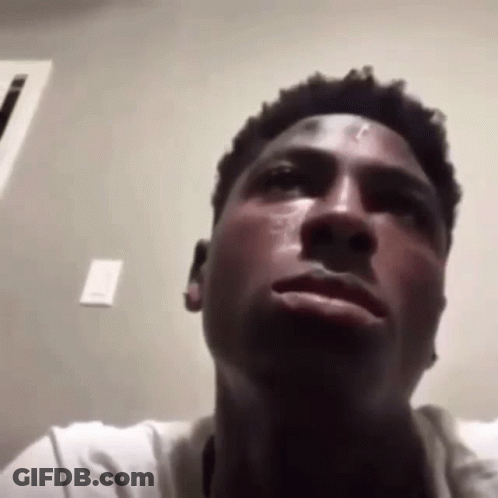 A Close Up Of A Man 'S Face With A Tear Running Down His Cheek . GIF