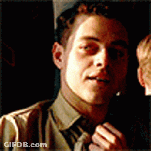 A Close Up Of A Man 'S Face With A Tie GIF