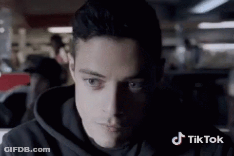 A Close Up Of A Man 'S Face With A Tiktok Logo In The Background GIF