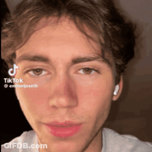 A Close Up Of A Man 'S Face With A Tiktok Watermark On It GIF