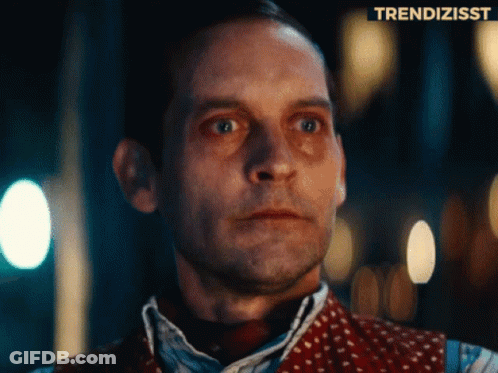 A Close Up Of A Man 'S Face With A Trendizsst Logo Above Him GIF