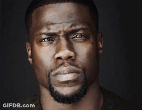 A Close Up Of A Man 'S Face With A Triangle In The Background GIF