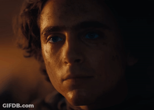 A Close Up Of A Man 'S Face With A Very Dark Background GIF
