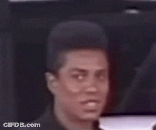 A Close Up Of A Man 'S Face With A Very Short Haircut . GIF