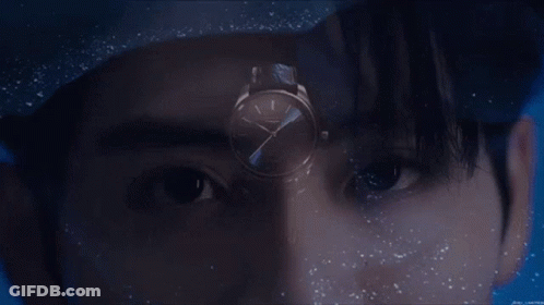 A Close Up Of A Man 'S Face With A Watch In The Foreground GIF