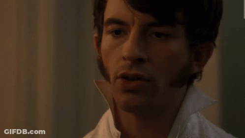 A Close Up Of A Man 'S Face With A White Collar GIF
