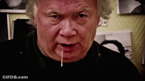 A Close Up Of A Man 'S Face With A White Liquid Coming Out His Mouth GIF