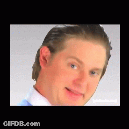 A Close Up Of A Man 'S Face With A White Shirt And Blue Shirt GIF