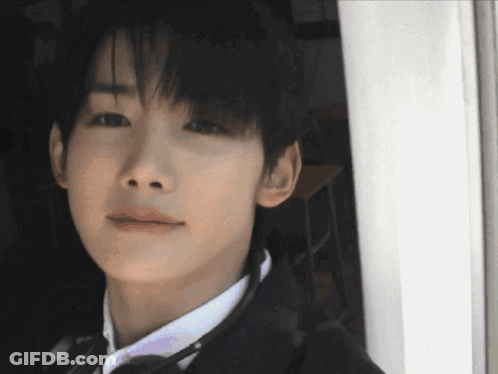 A Close Up Of A Man 'S Face With A White Shirt And Tie GIF