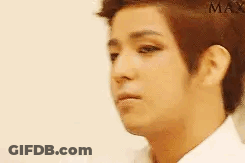 A Close Up Of A Man 'S Face With A White Shirt On And A Serious Look On His Face . GIF