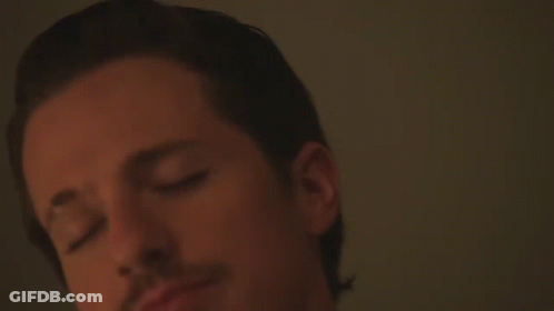 A Close Up Of A Man 'S Face With A White Shirt On GIF