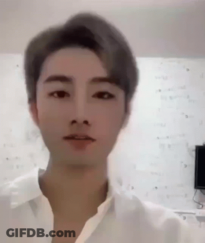 A Close Up Of A Man 'S Face With A White Shirt On . GIF