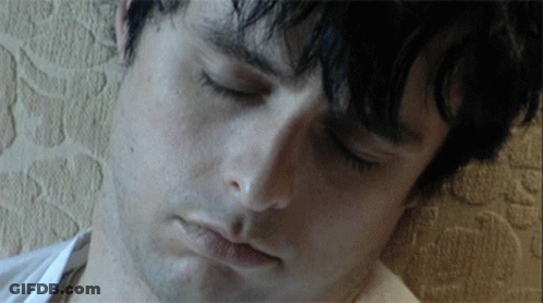 A Close Up Of A Man 'S Face With A White Shirt On GIF