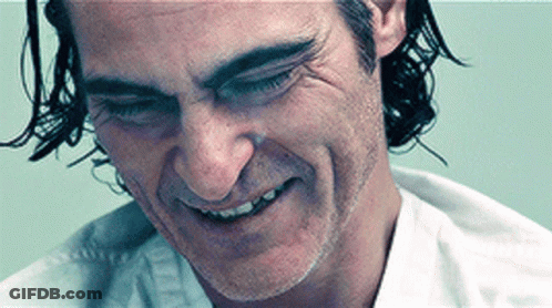 A Close Up Of A Man 'S Face With A White Shirt On GIF