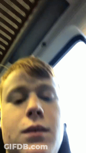 A Close Up Of A Man 'S Face With A Window In The Background GIF