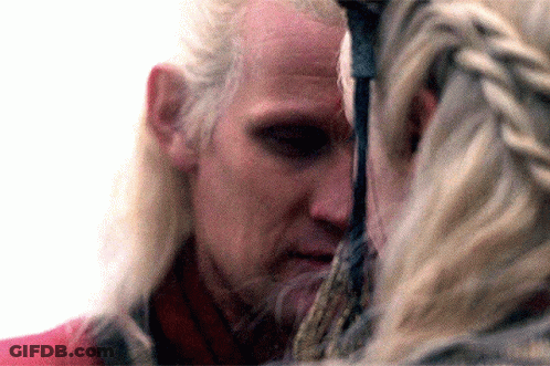 A Close Up Of A Man 'S Face With A Woman Behind Him GIF
