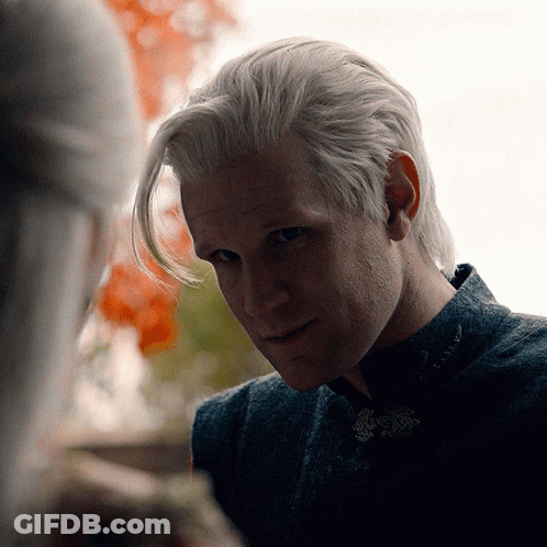 A Close Up Of A Man 'S Face With A Woman Behind Him GIF