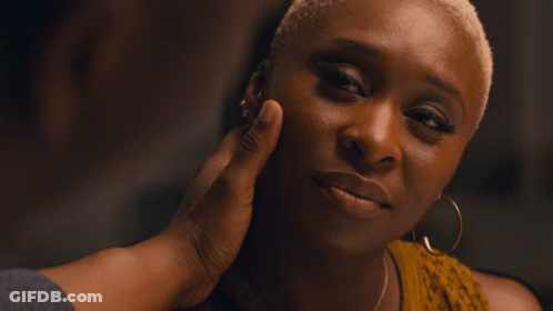A Close Up Of A Man 'S Face With A Woman In The Background GIF