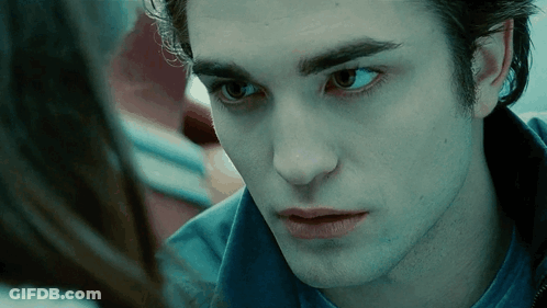 A Close Up Of A Man 'S Face With A Woman Looking At Him . GIF