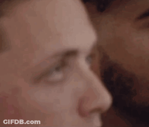 A Close Up Of A Man 'S Face With A Woman 'S Face Behind Him . GIF